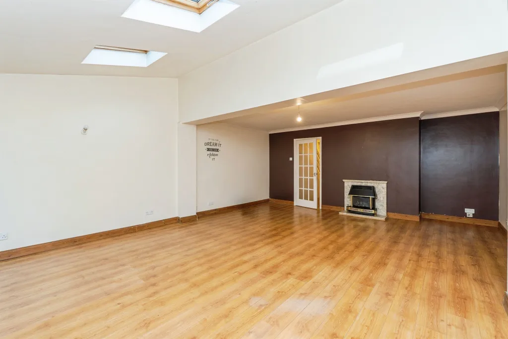 Enjoy a large open-plan lounge/diner with wooden flooring, skylights, and direct access to the rear garden.